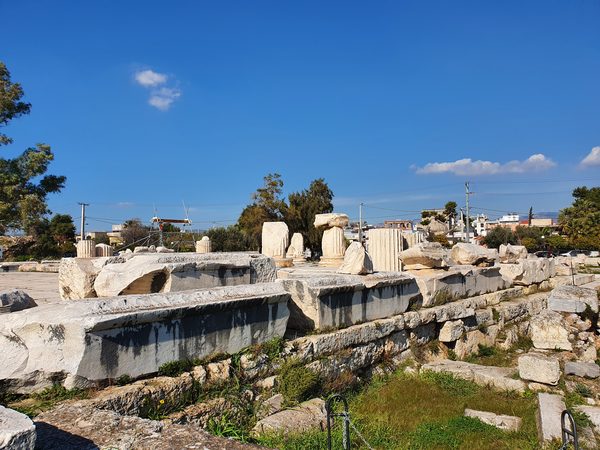 Terraced ruins of the Sanctuary of Eleusis with the modern town of Elefsina rising directly behind the ancient site