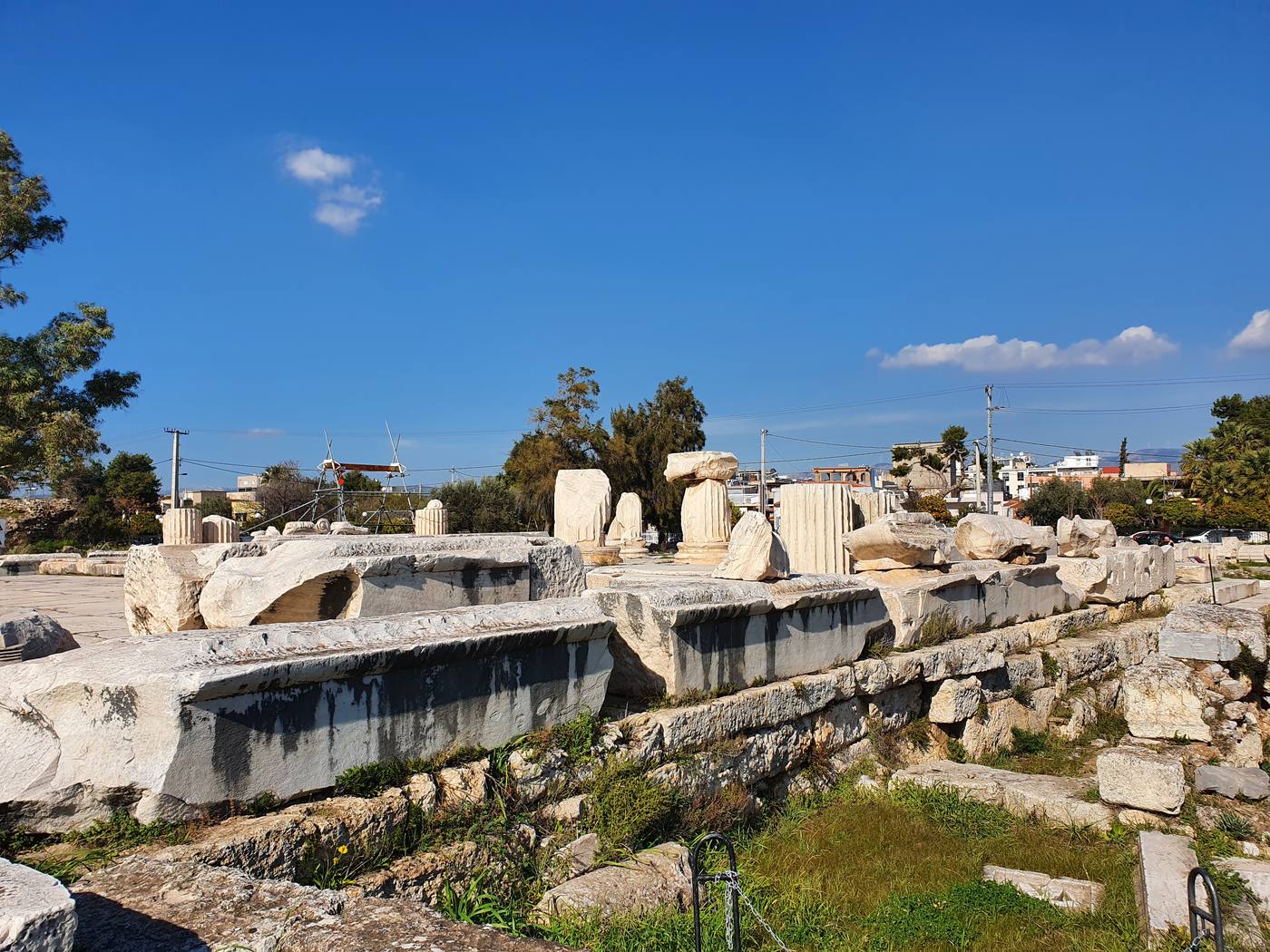 Terraced ruins of the Sanctuary of Eleusis with the modern town of Elefsina rising directly behind the ancient site