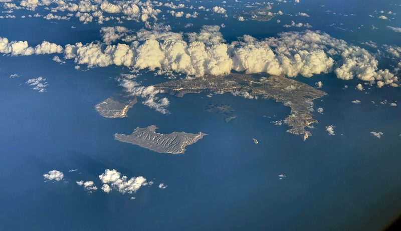 Aerial view of Santorini island showing the caldera and white-washed villages along the cliff edge