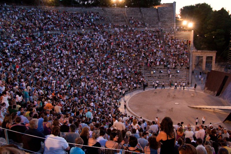 Evening performance at the ancient Theatre of Epidaurus with audience filling the stone seats during the Athens-Epidaurus Festival