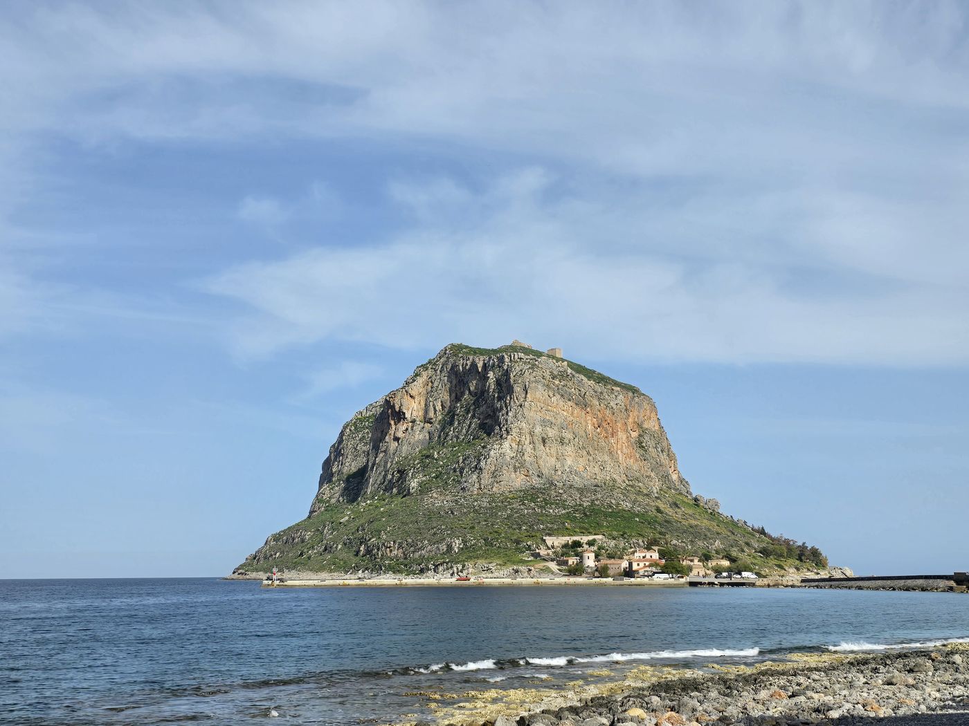 The great rock of Monemvasia rising from the sea, with the walled lower town visible at its base